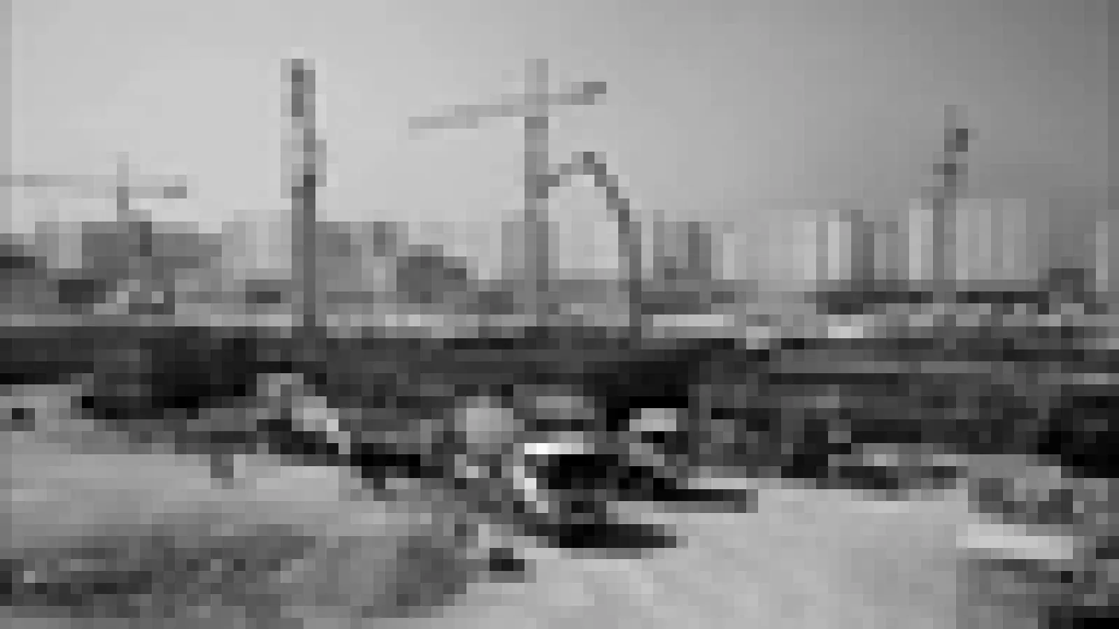 Pixelated black and white still of a construction site